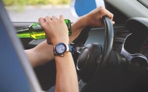 Drunk Driving Accident - Driver Behind the wheel drinking a beer