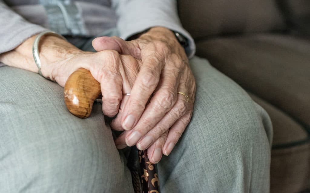Elderly Hands Pictured - what to do if you suspect a loved one is the victim of nursing home abuse.