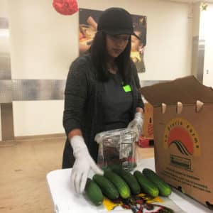 KFB Law volunteer Kirina sorts vegetables at Feeding Tampa Bay