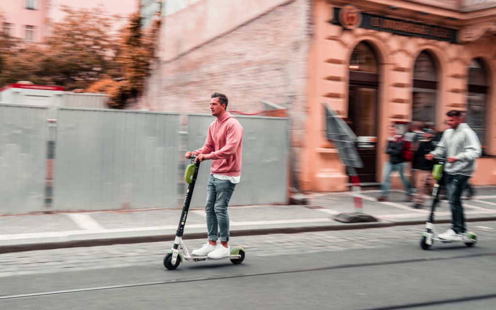 Man on electric scooter riding on the street
