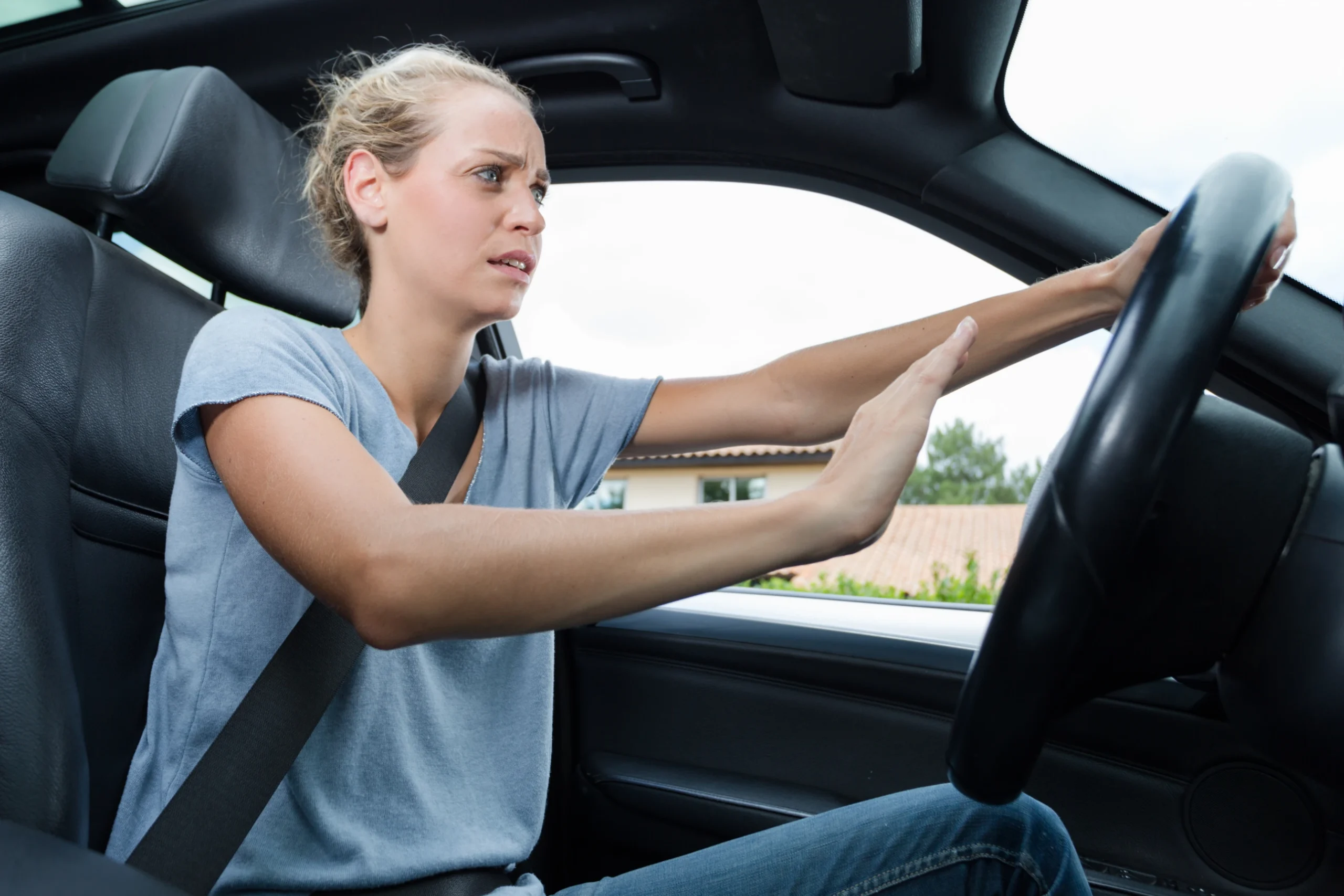 woman honks horn in motor vehicle to avoid another driver driving aggressively